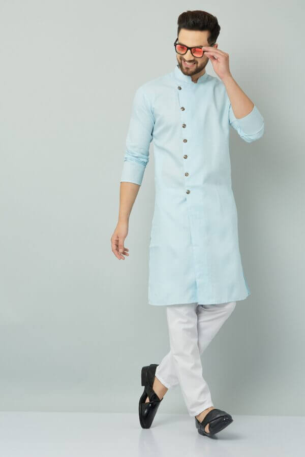 Traditional Indian men's blue kurta paired with white pants and black shoes.